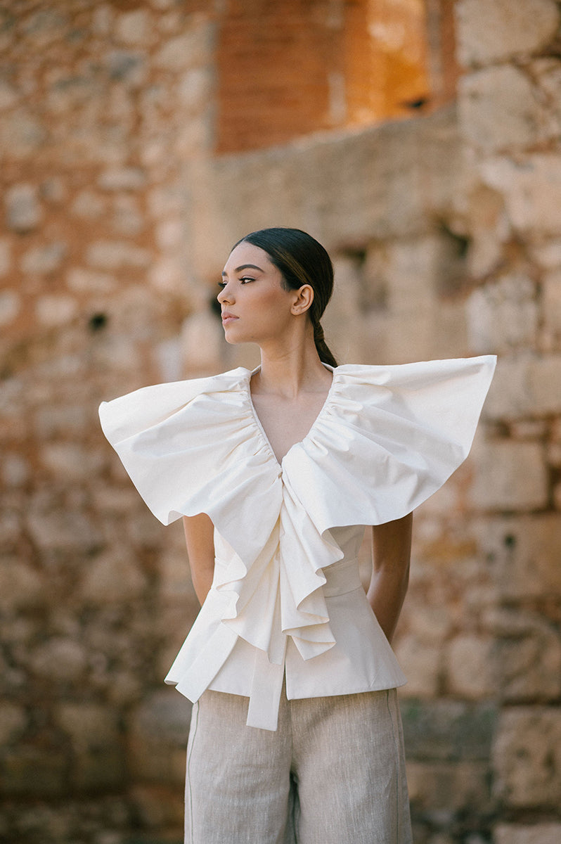 Ivory Palma blouse by ANA + MARIA, featuring lightweight fabric and stylish design, displayed on a model in a fashion campaign.
