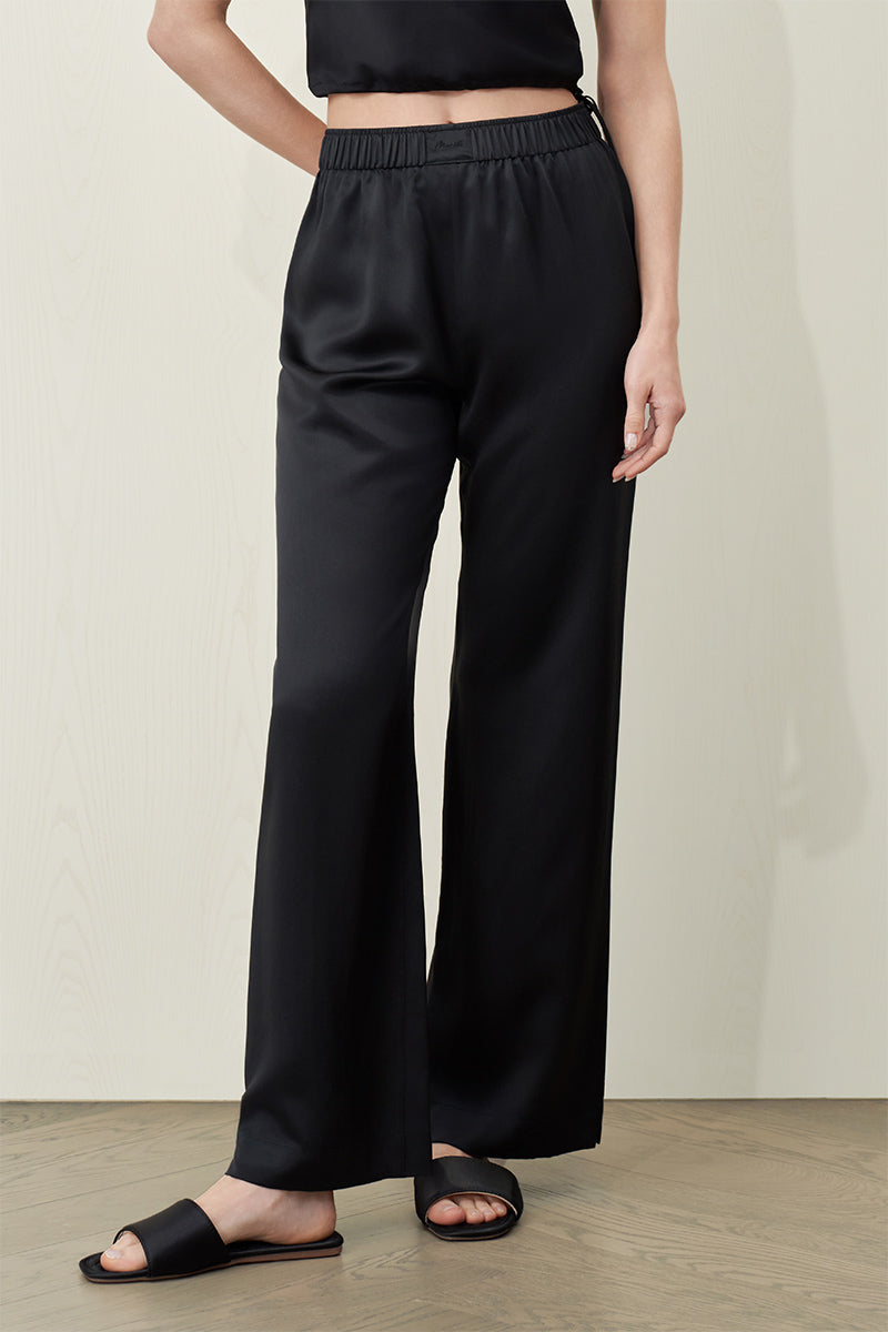 Black silk trousers for women by MANITO, featuring a sleek, elegant design with a comfortable fit.