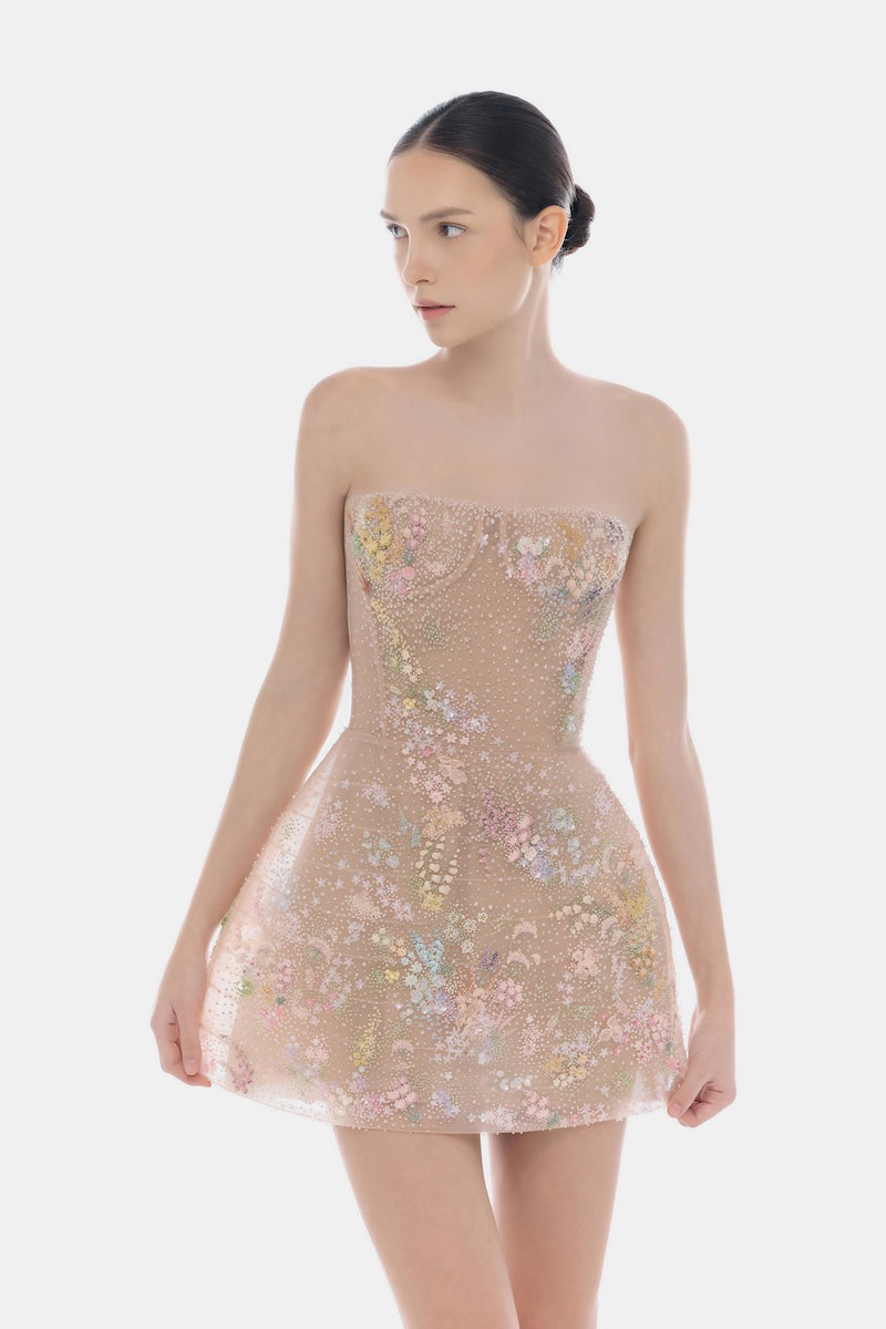 Pastel flower-embellished mini dress by Montsand, featuring a flowy design and delicate floral accents, perfect for spring.