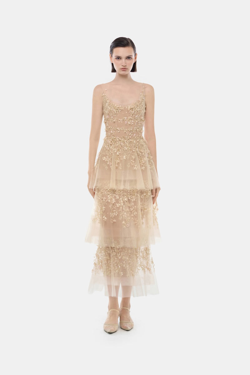 Light pastel tiered midi dress by Montsand featuring flowing fabric and a feminine, layered design for elegant summer wear.