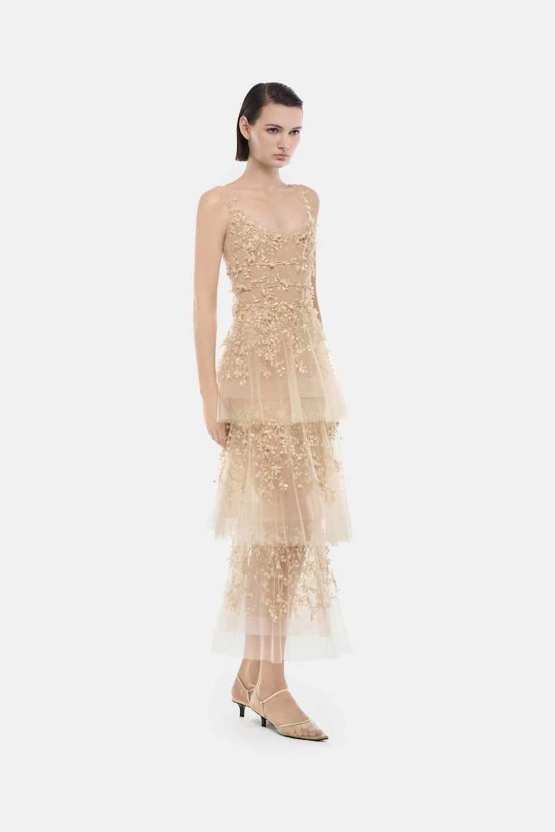 Light pink pastel tiered midi dress by Montsand with flowing fabric and layered design, perfect for spring and summer wear.
