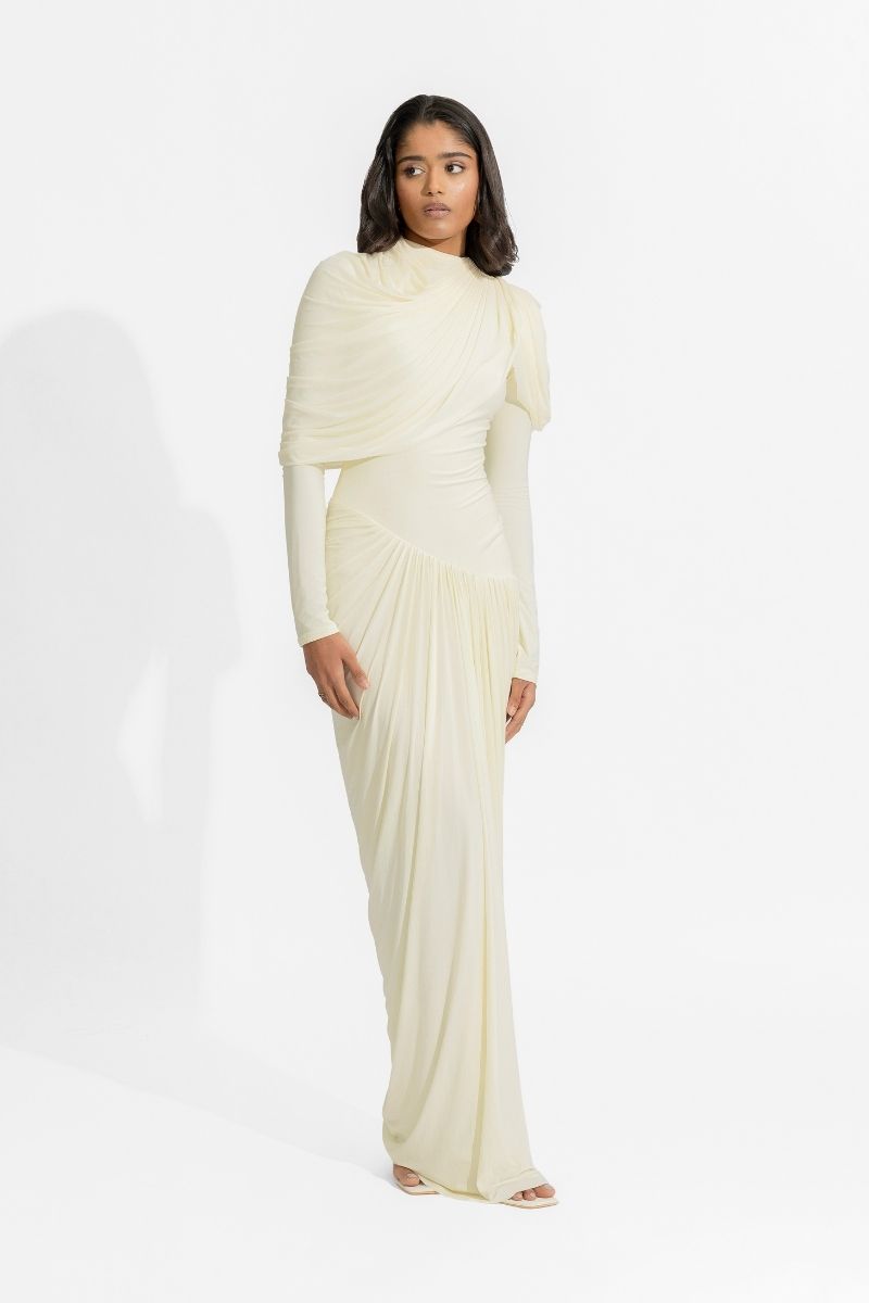 Deme By Gabriella Paulina off-white gown with elegant flowing fabric and intricate detailing, perfect for formal occasions.