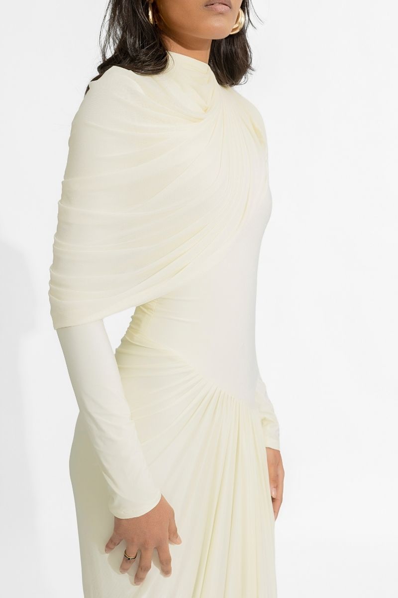 Deme By Gabriella Paulina off-white gown featuring elegant fabric and a flowing silhouette.