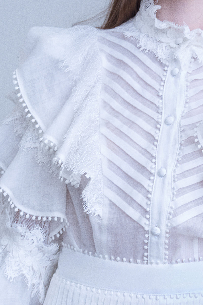 A white pearl shirt from AISA featuring a classic collar and button-down front, displayed on a hanger.