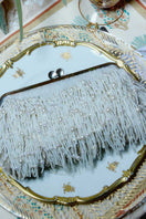 White Pearl Cascade Hold Me clutch bag by Sarah's Bag featuring pearl embellishments and a sleek, elegant design.