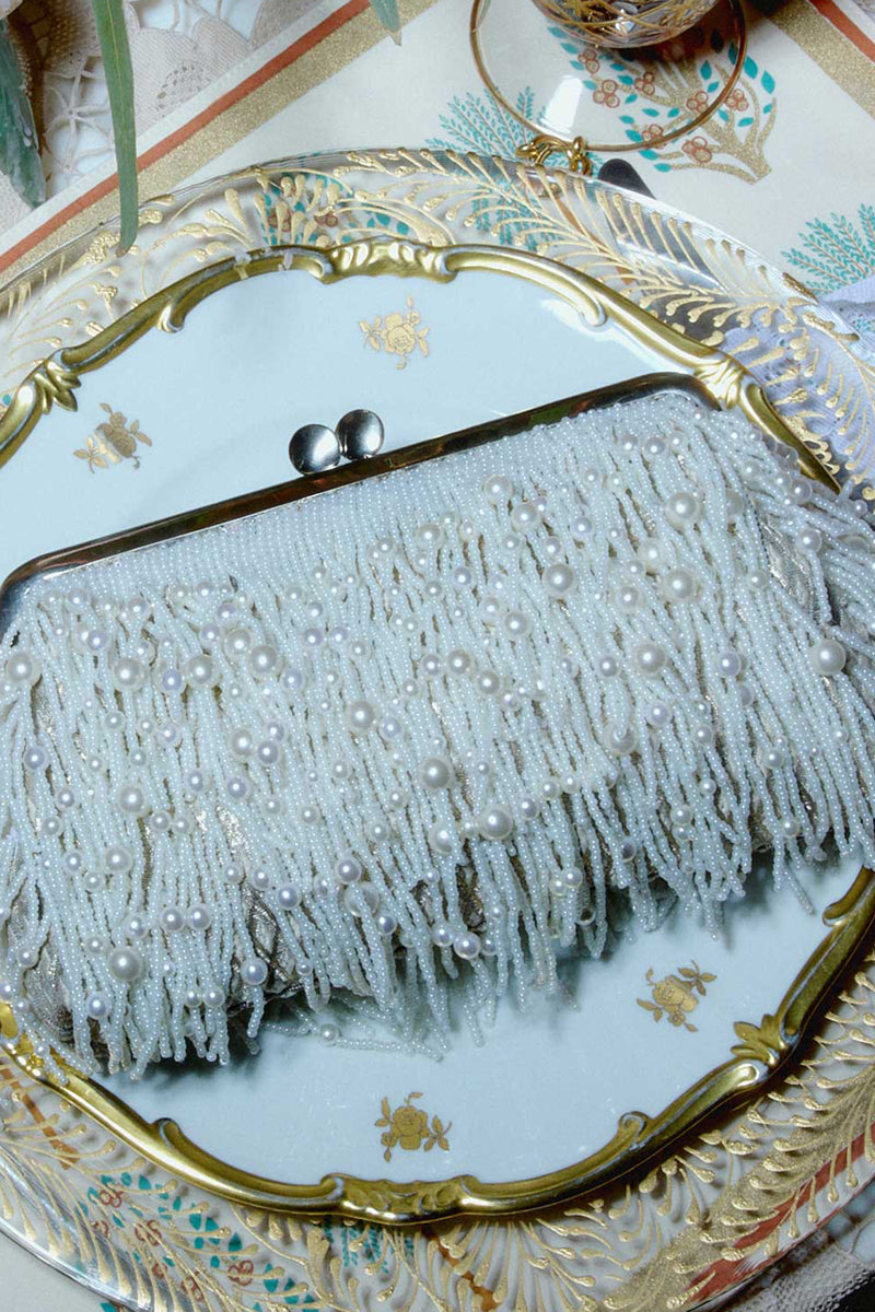 White Pearl Cascade Hold Me clutch bag by Sarah's Bag featuring pearl embellishments and a sleek, elegant design.