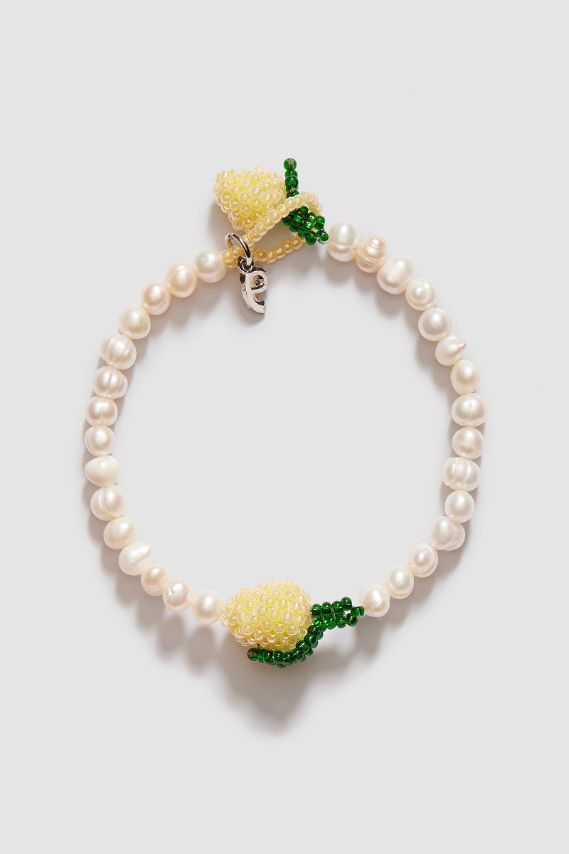 Pura Utz Pearl Lemon bracelet featuring a string of yellow and white pearls on a delicate bracelet band.