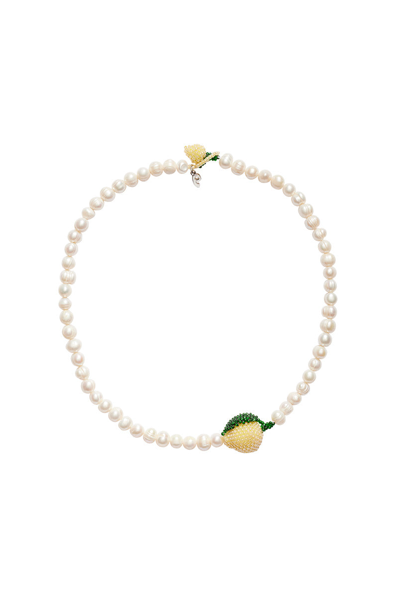Elegant Pearl Lemon Necklace by Pura Utz featuring a string of freshwater pearls with lemon-shaped pendant.