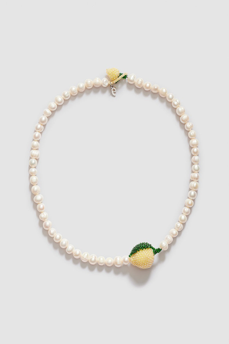 Pura Utz Pearl Lemon Necklace featuring a string of pearl and lemon-shaped beads on a delicate chain.