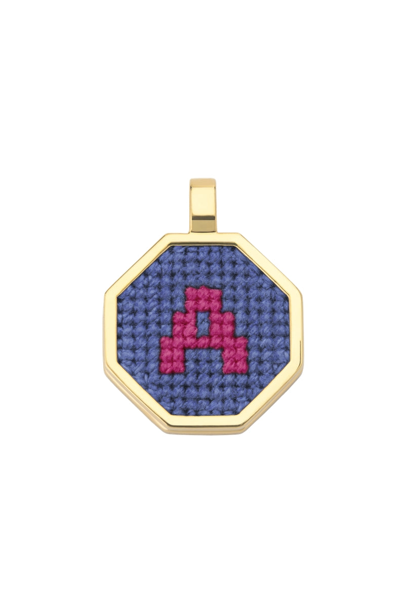 Blue personalized letter pendant necklace by Maria Frering featuring a custom engraved letter on a delicate chain.
