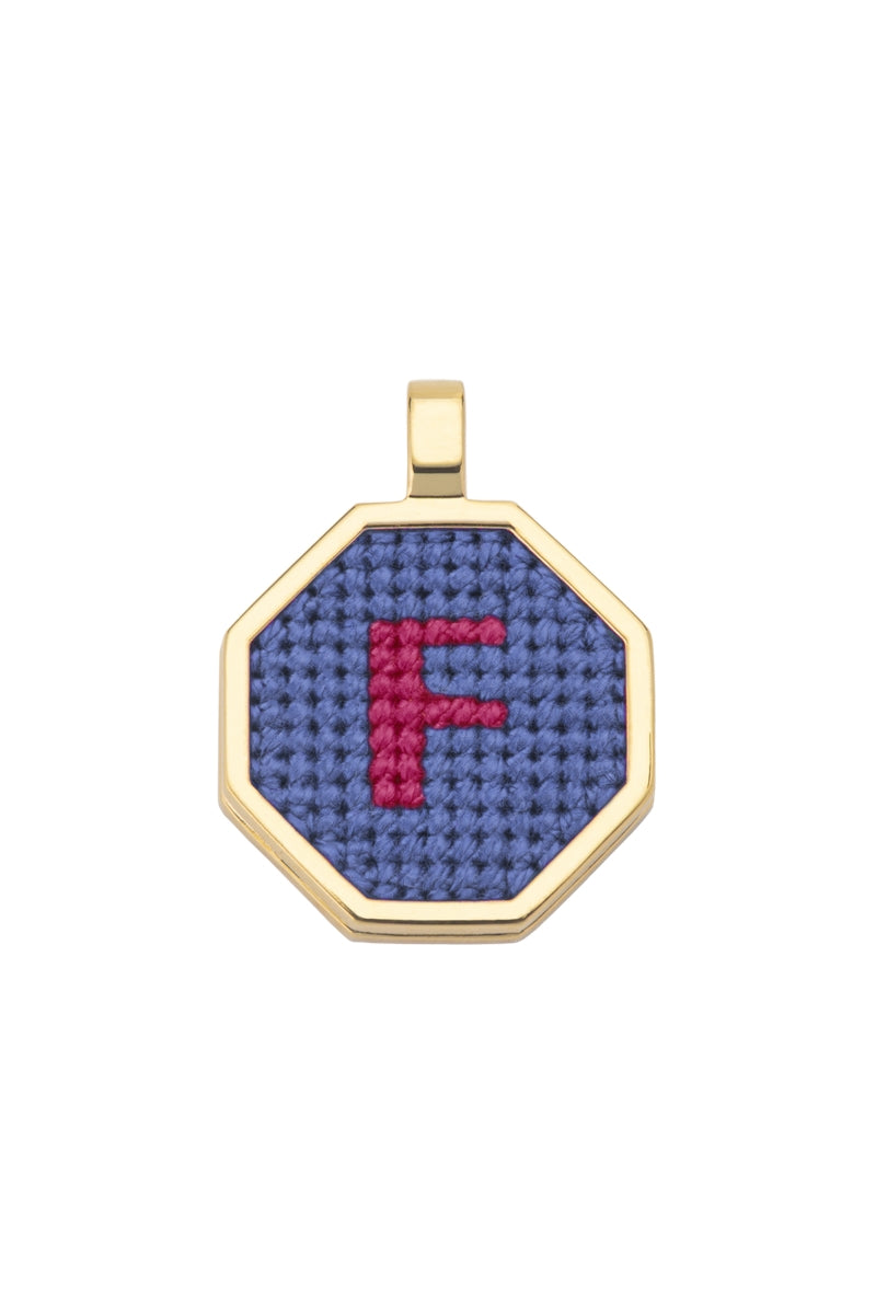 Blue personalized letter pendant necklace by Maria Frering featuring a custom engraved letter charm.