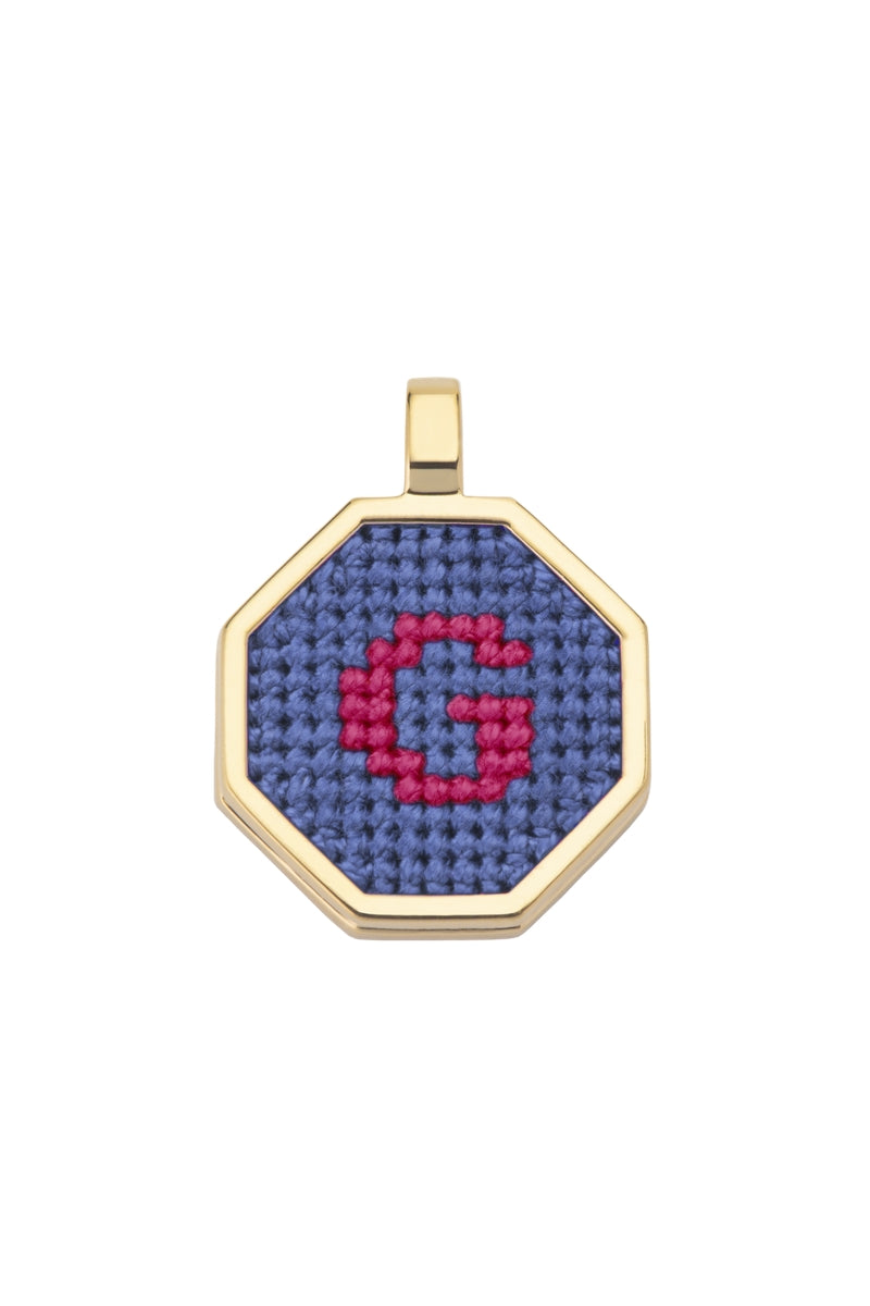 Blue personalized letter pendant necklace by Maria Frering, featuring a custom engraved initial on a delicate chain.