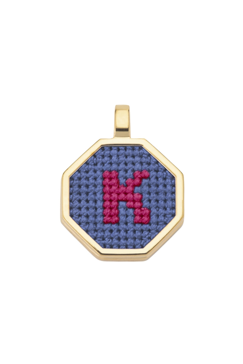 Blue personalised letter pendant necklace by Maria Frering, featuring a custom engraved letter on a delicate chain.