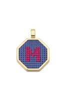 Blue personalized letter pendant necklace by Maria Frering, showcasing a custom engraved initial on a delicate chain.