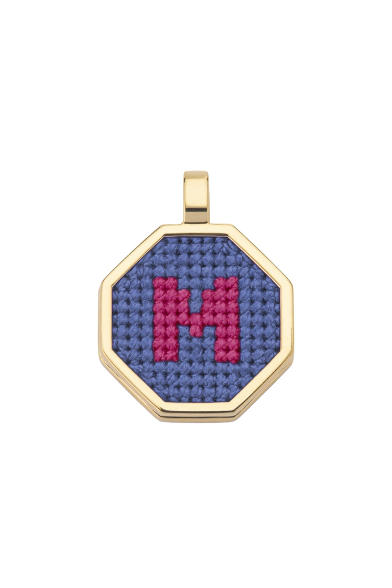 Blue personalized letter pendant necklace by Maria Frering, showcasing a custom engraved initial on a delicate chain.
