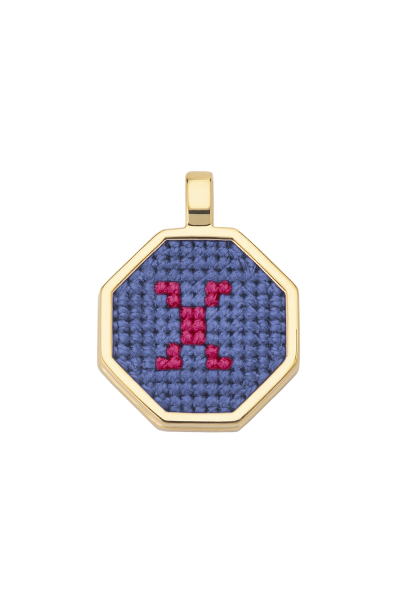 Blue personalized letter pendant necklace by Maria Frering, featuring a custom engraved initial on a delicate chain.