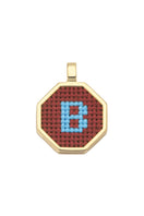 Personalised letter pendant necklace by Maria Frering featuring a brown leather cord and a custom engraved letter charm.