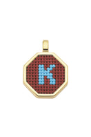 Personalised letter pendant necklace by Maria Frering featuring a brown leather cord and custom engraved initial charm.