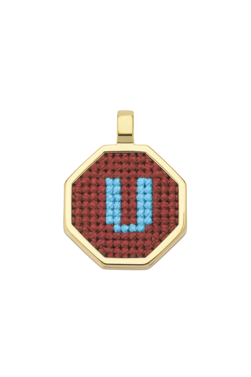 Personalised letter pendant necklace by Maria Frering with a brown leather cord and a custom engraved initial charm.