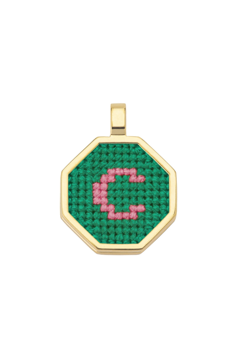 Personalised letter pendant necklace by Maria Frering featuring a green charm with custom initial design.