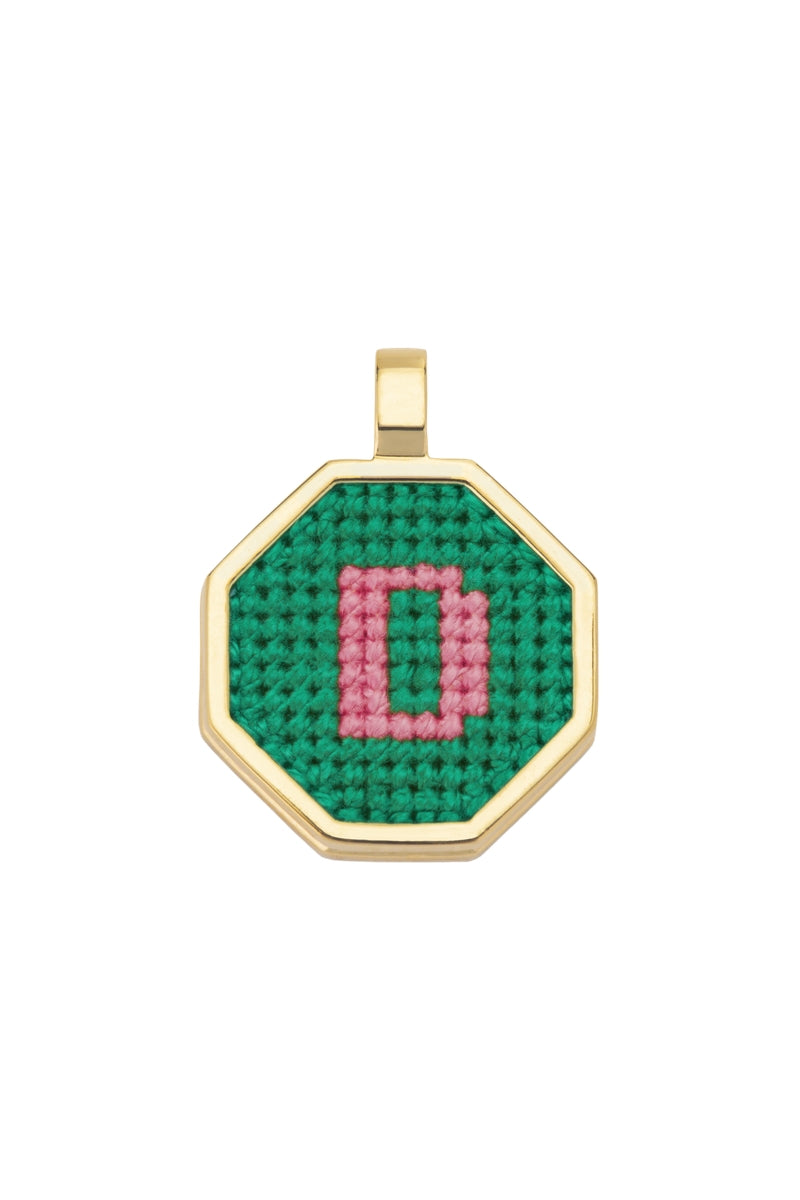 Personalised letter pendant necklace by Maria Frering with a green gemstone accent on a silver chain.
