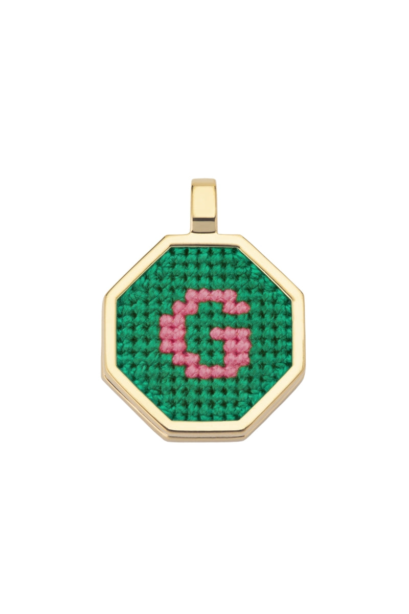 Green personalized letter pendant necklace by Maria Frering, featuring a custom engraved initial on a delicate chain.