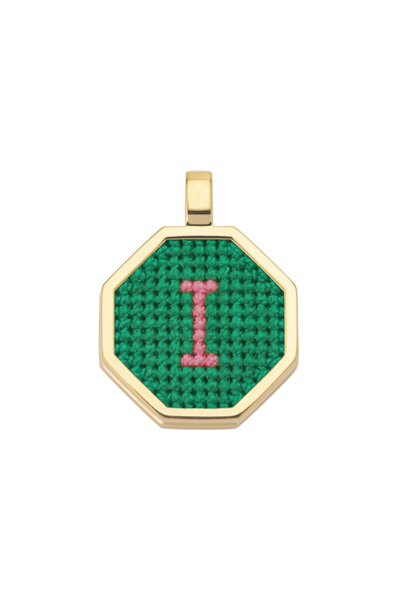 Personalised letter pendant necklace by Maria Frering with a green gemstone accent, showcasing a custom initial charm.