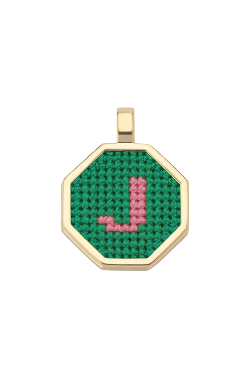 Personalised letter pendant necklace by Maria Frering with a green charm, featuring a custom initial on a delicate chain.