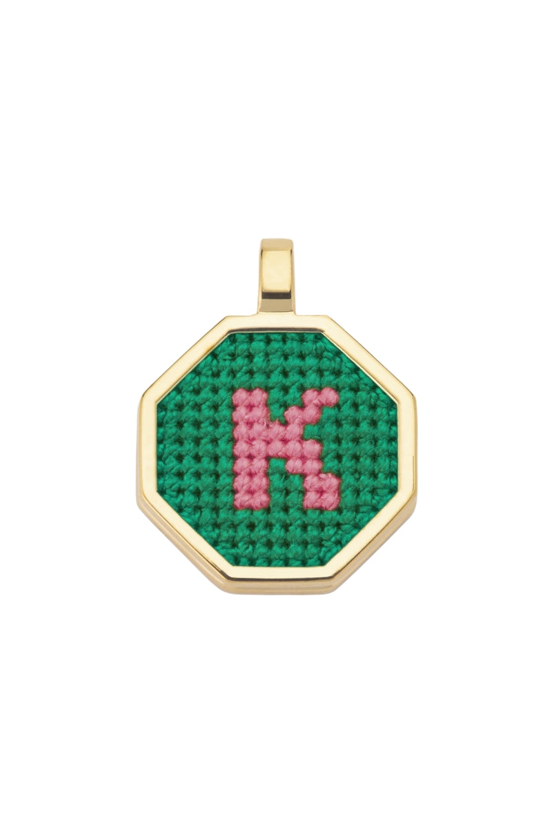 Personalised letter pendant necklace by Maria Frering featuring a green letter charm, stylish and customizable jewelry accessory.