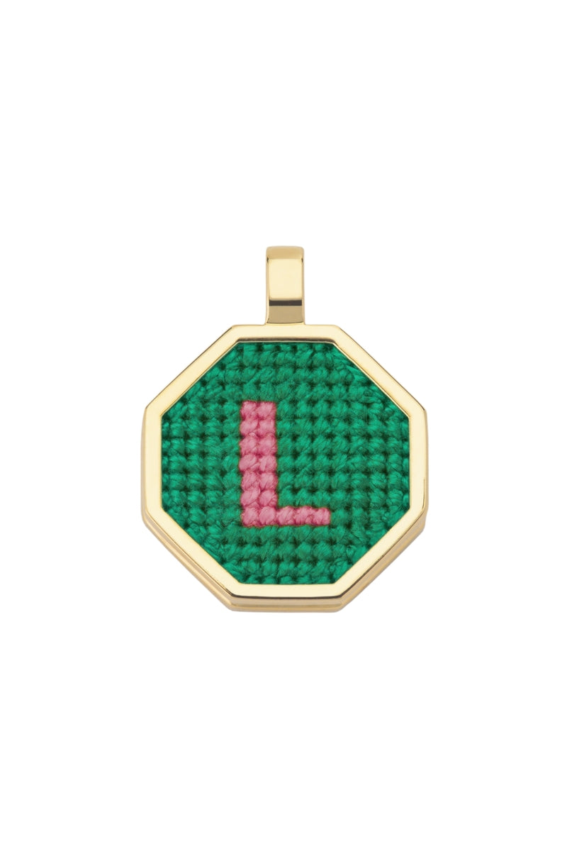 Personalised letter pendant necklace by Maria Frering featuring a green charm on a delicate chain.