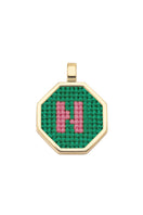 Personalised letter pendant necklace by Maria Frering with a green letter charm, stylish and elegant jewelry accessory.