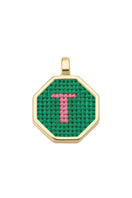 Personalised letter pendant necklace by Maria Frering with a green gemstone accent, featuring custom engraved initial design.