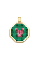 Personalised letter pendant necklace by Maria Frering featuring a green gemstone and custom initial charm.