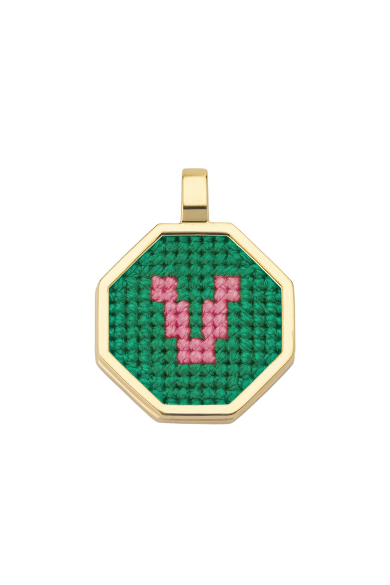 Personalised letter pendant necklace by Maria Frering featuring a green gemstone and custom initial charm.