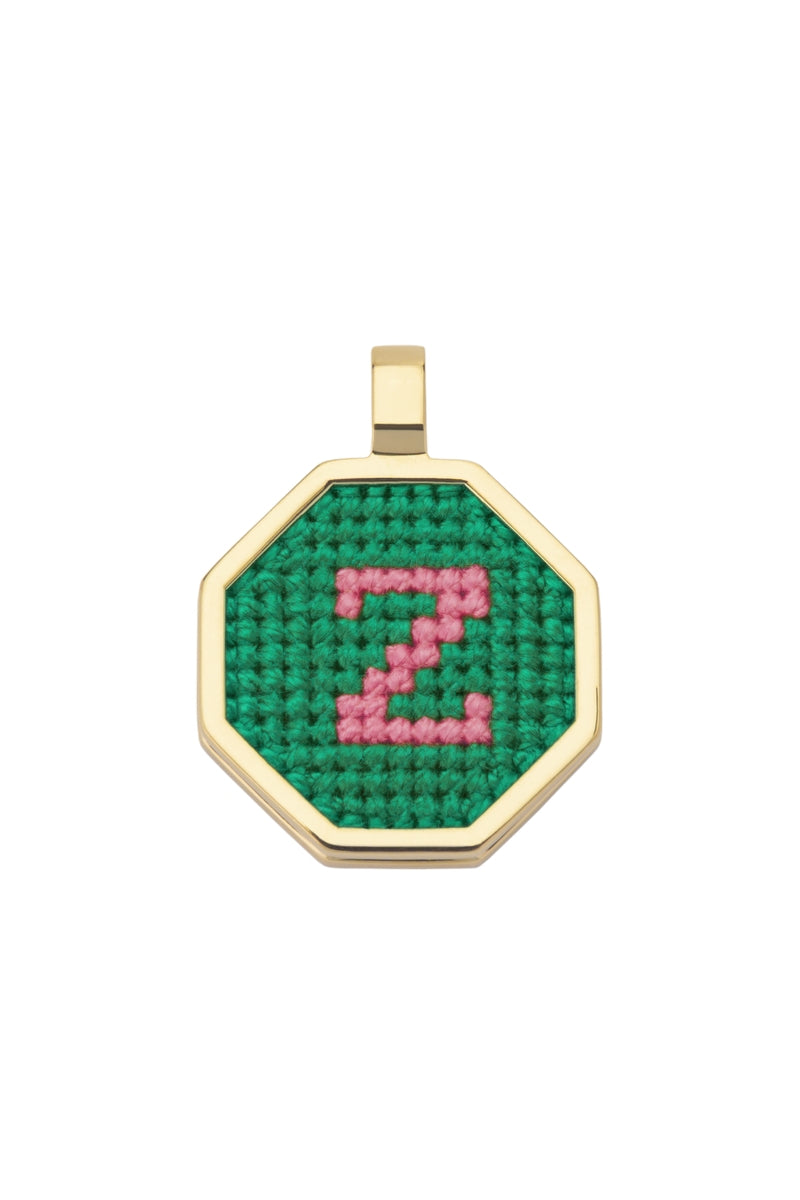 Personalised letter pendant necklace by Maria Frering with green gemstone detail, featuring a custom initial charm.