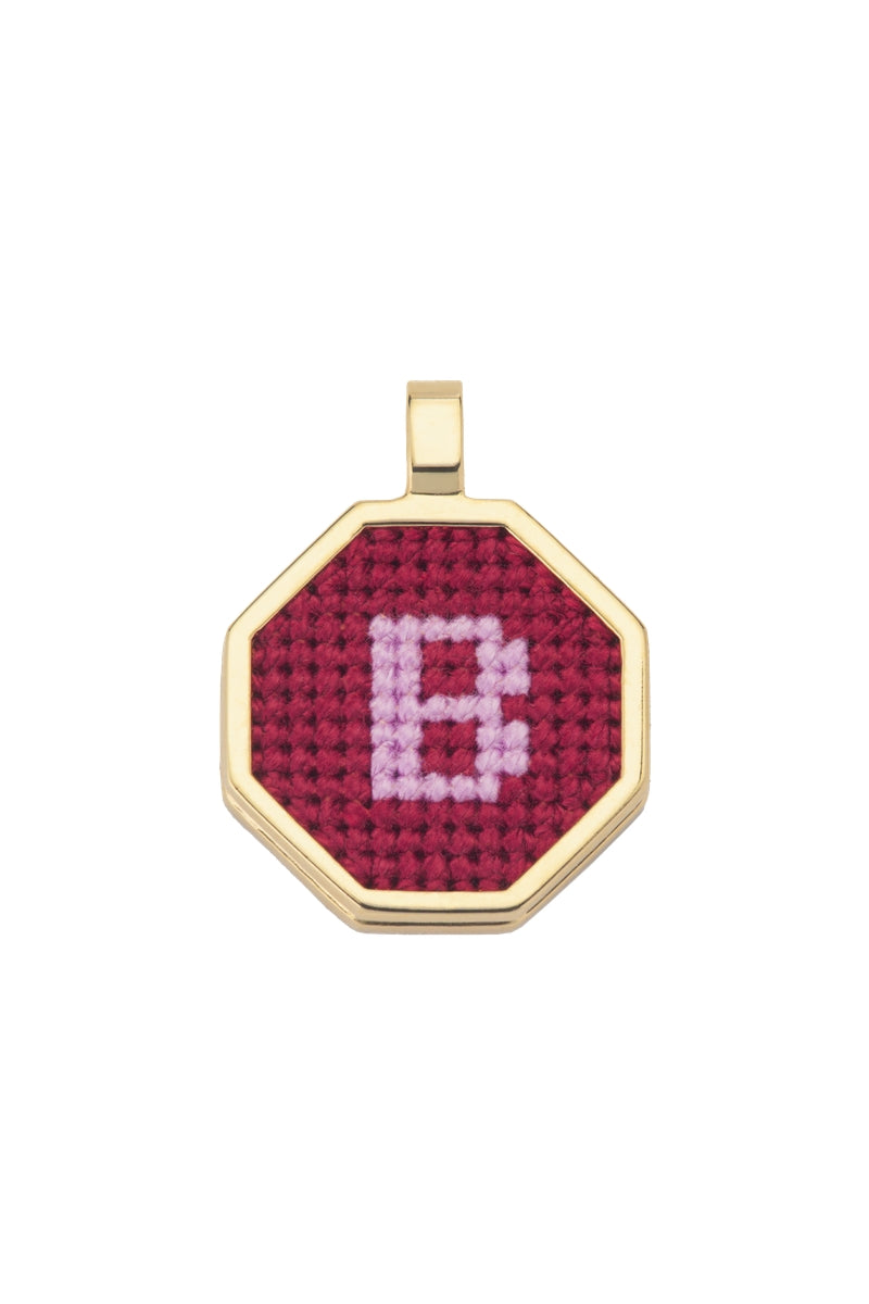 Personalised letter pendant necklace by Maria Frering featuring a red pendant with custom initial.