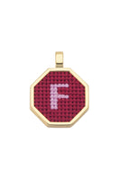 Red personalized letter pendant necklace by Maria Frering featuring a custom engraved initial.