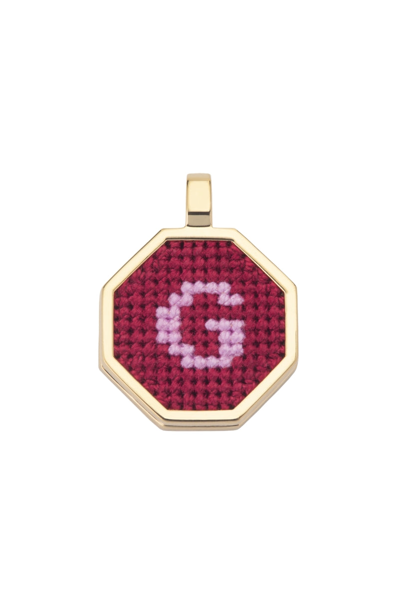 Red personalized letter pendant necklace by Maria Frering featuring a custom initial charm.