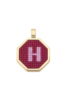 Red personalized letter pendant necklace by Maria Frering, featuring a custom engraved letter on a delicate chain.