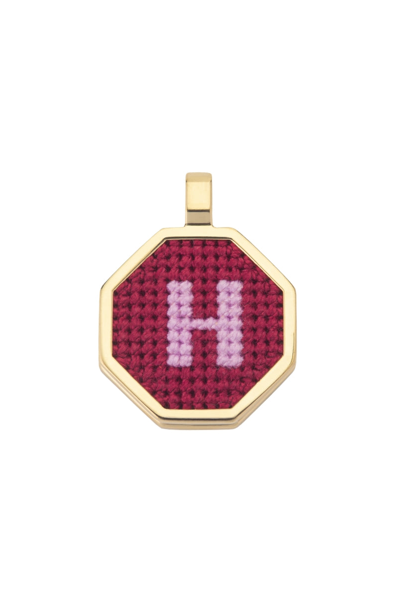 Red personalized letter pendant necklace by Maria Frering, featuring a custom engraved letter on a delicate chain.