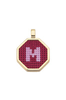 Red personalized letter pendant necklace by Maria Frering showing a close-up of the custom engraved pendant.