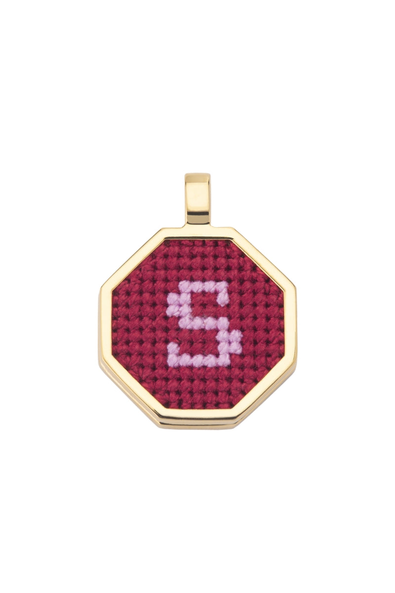 Red personalized letter pendant necklace by Maria Frering, featuring a custom engraved initial on a sleek chain.