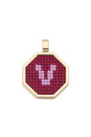 Red personalized letter pendant necklace by Maria Frering, featuring a custom initial charm on a delicate chain.