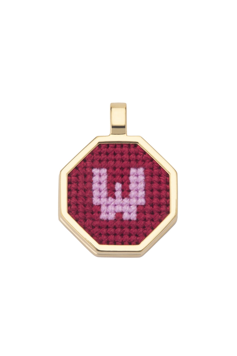 Red personalized letter pendant necklace by Maria Frering featuring custom initial charm on a delicate chain.