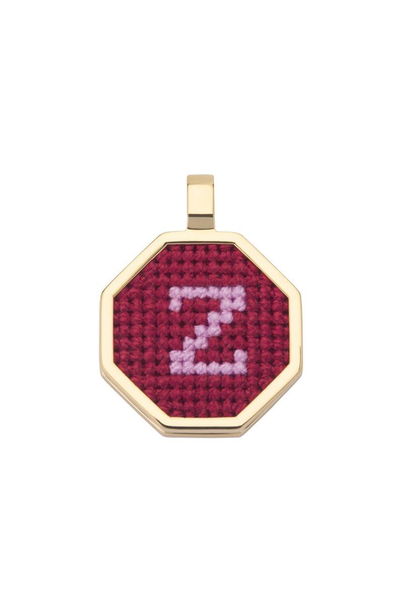 Red personalized letter pendant necklace by Maria Frering, featuring a custom engraved letter on a delicate chain.