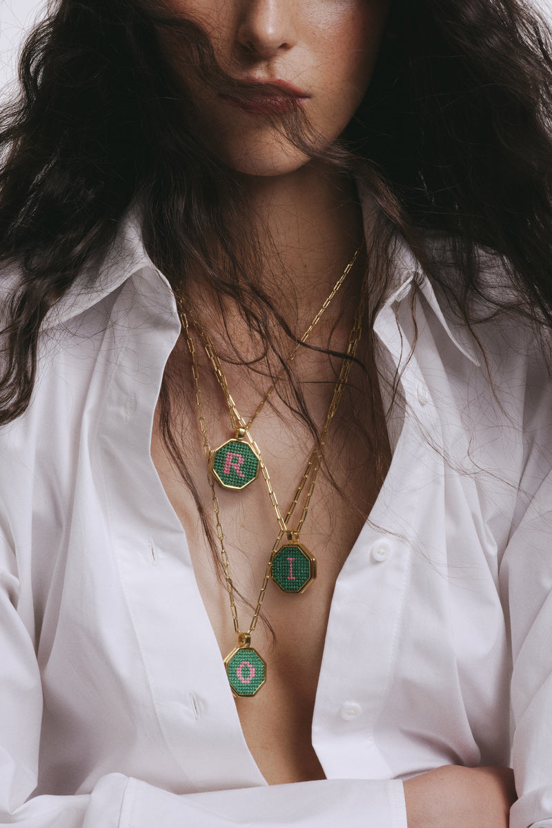 Personalized letter pendant necklace by Maria Frering featuring a custom engraved letter on a delicate chain.