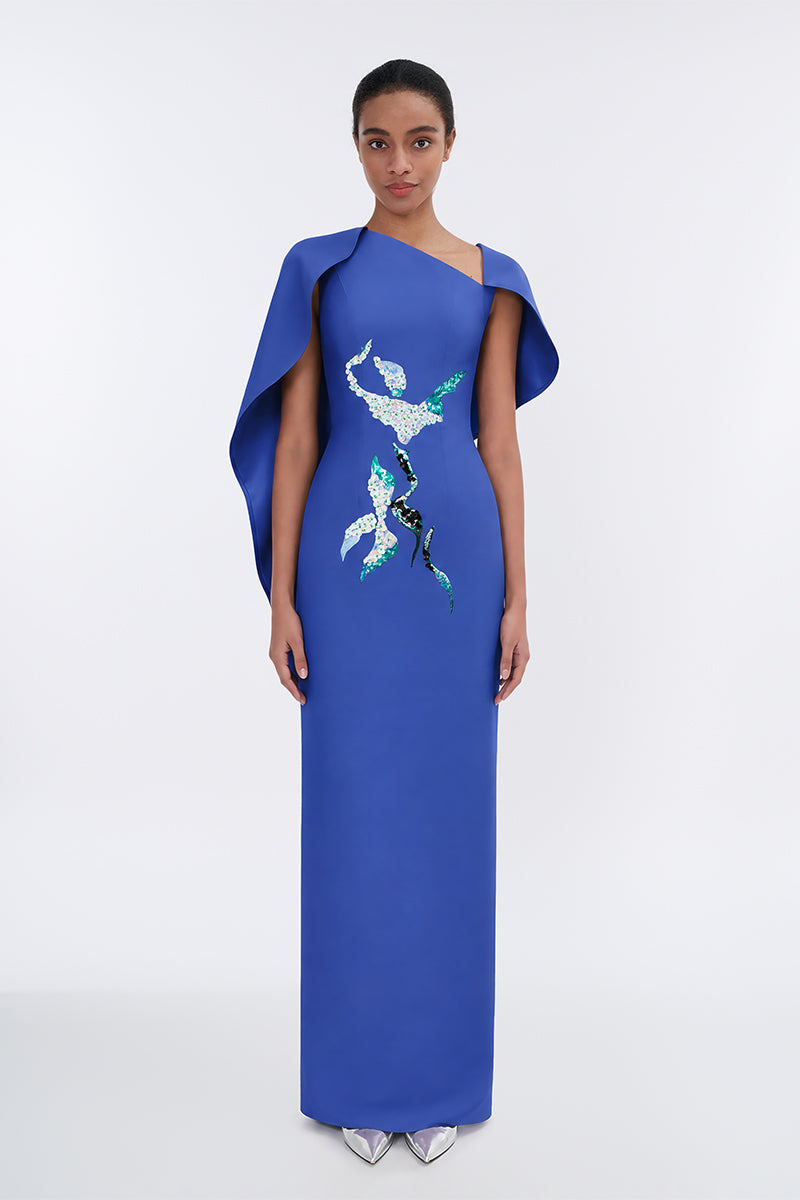 Elegant Petal's Secret Dance asymmetrical cape evening gown by Tiny Ink, featuring flowing fabric and a stylish, dramatic silhouette.