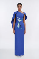 Elegant Petal's Secret Dance asymmetrical cape evening gown by Tiny Ink, featuring flowing fabric and a stylish, dramatic silhouette.