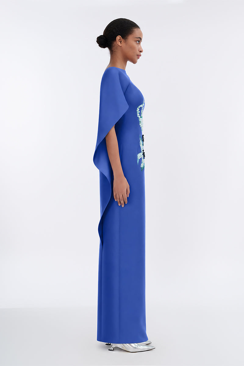 Elegant Petal's Secret Dance asymmetrical cape evening gown by Tiny Ink featuring flowing fabric and stylish design.