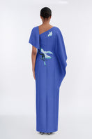 Elegant petal-colored asymmetrical evening gown with a cape, designed by Tiny Ink, featuring flowing fabric and stylish draping.